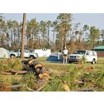 Campsite behind Emergency Operations Center (EOC) at <br> Hancock Co. Mississippi Vo-Tech school. <br> Note Hurricane Katrina damage to trees and trailer.