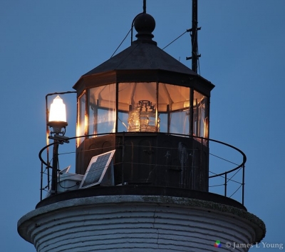 Lighthouse at night with lantern room and lens illuminated - St Marks NWR.